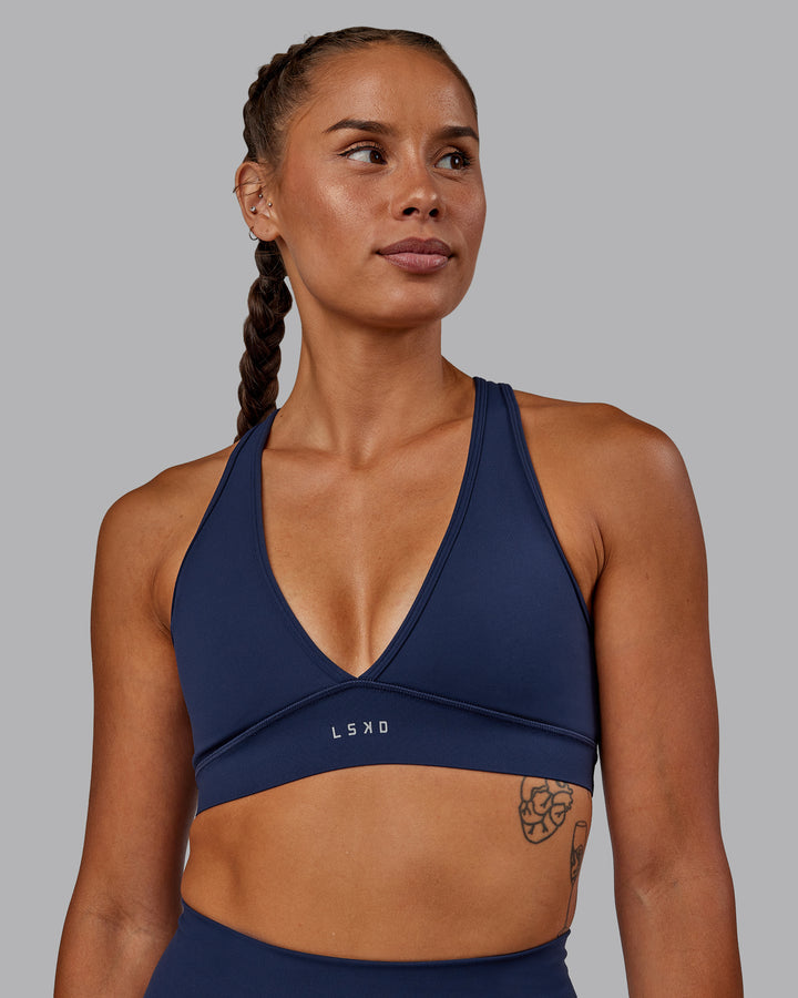 Woman wearing Stamina Sports Bra - Future Navy
