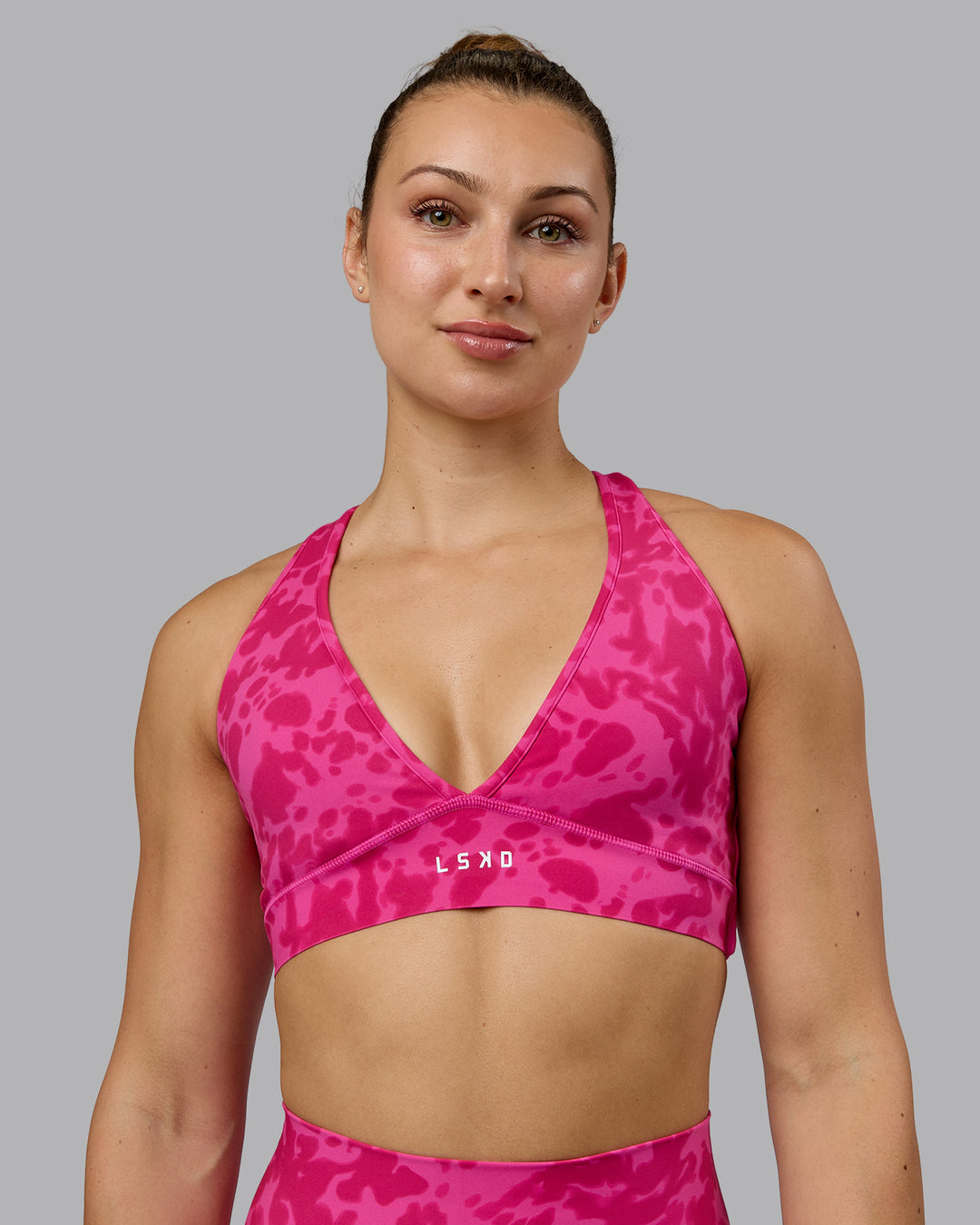 Woman wearing Stamina Sports Bra - Strawberry-Lava Lamp