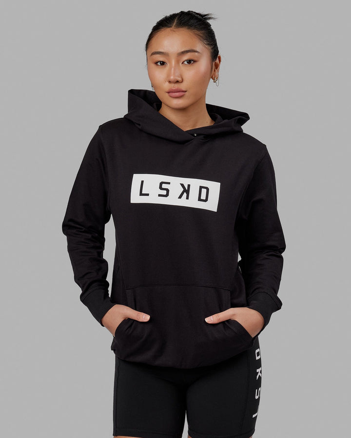 Woman wearing Unisex Strength FLXFLeece Hoodie - Black-White
