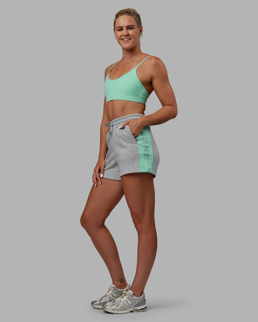 Woman wearing Tenacity Lounge Shorts - Light Grey Marl-Ice Green