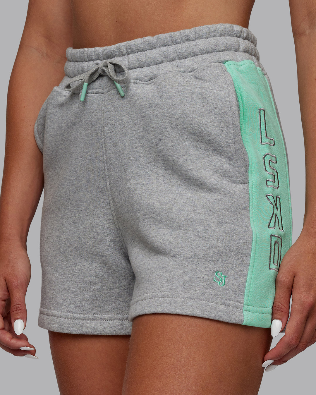 Woman wearing Tenacity Lounge Shorts - Light Grey Marl-Ice Green