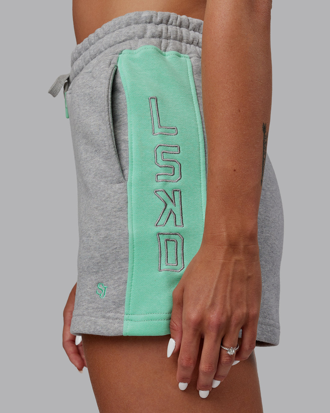 Woman wearing Tenacity Lounge Shorts - Light Grey Marl-Ice Green