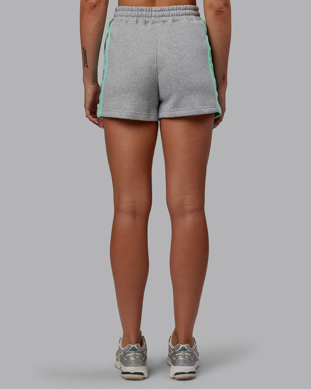 Woman wearing Tenacity Lounge Shorts - Light Grey Marl-Ice Green