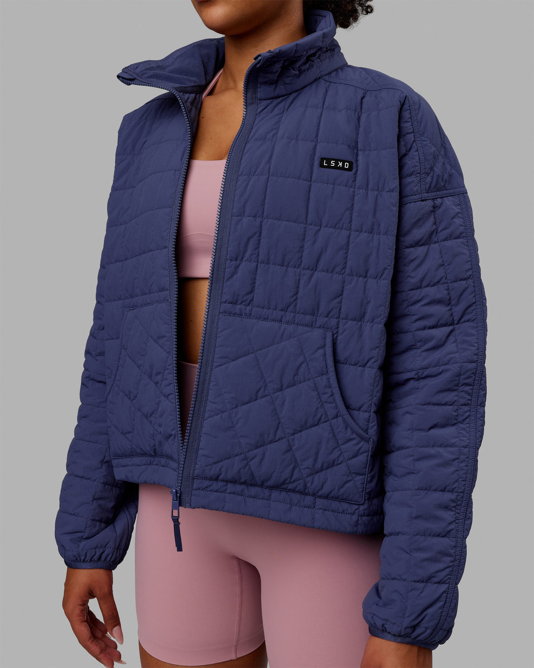 Woman wearing Thrive Packable Jacket - Future Dusk