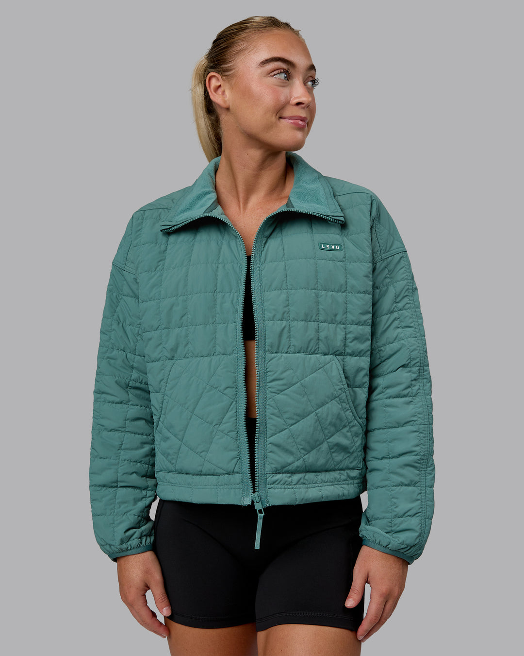 Woman wearing Thrive Packable Jacket - Sagebush