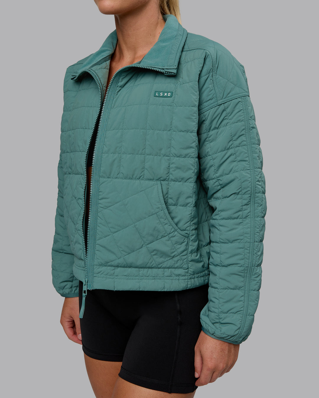 Woman wearing Thrive Packable Jacket - Sagebush