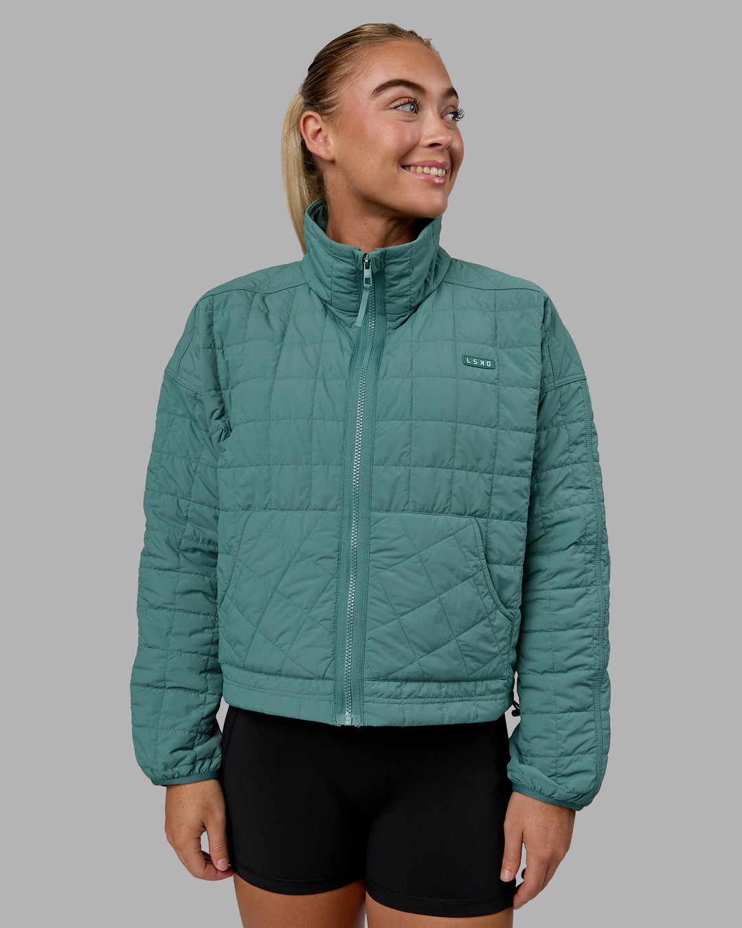 Woman wearing Thrive Packable Jacket - Sagebush