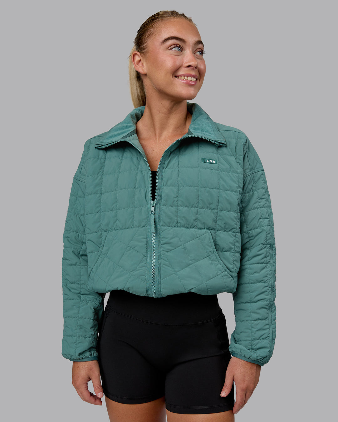 Woman wearing Thrive Packable Jacket - Sagebush