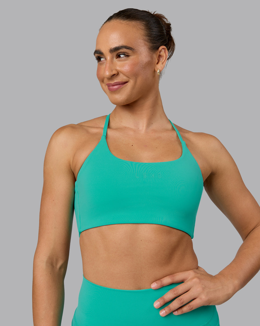 Woman wearing Twist Sports Bra - Atlantis