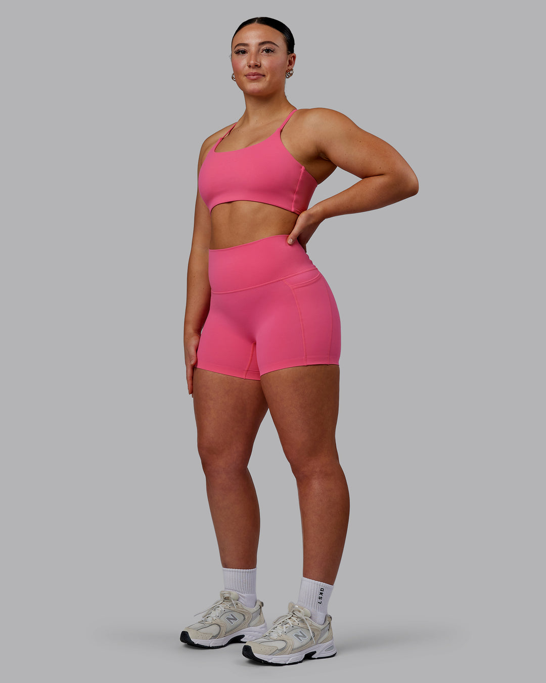 Woman wearing Twist Sports Bra - Carmine Rose