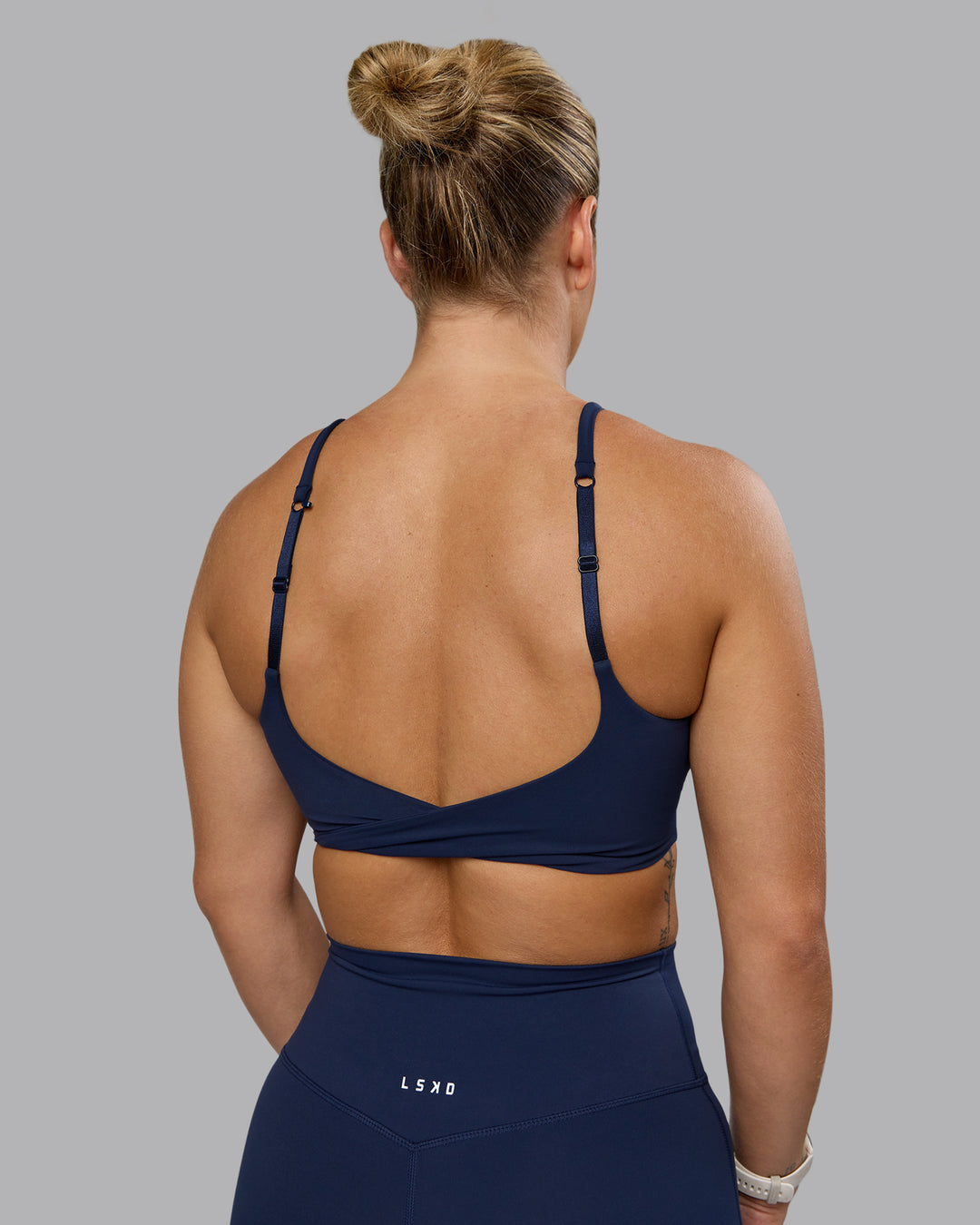 Woman wearing Twist Sports Bra - Future Navy