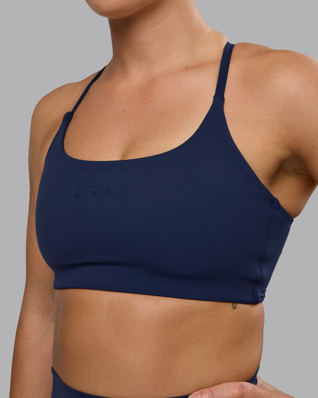 Woman wearing Twist Sports Bra - Future Navy