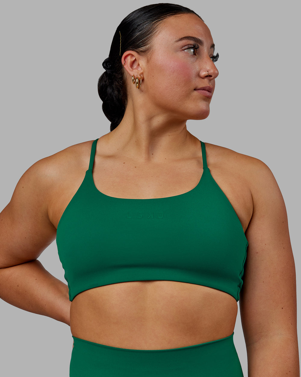 Woman wearing Twist Sports Bra - Malachite