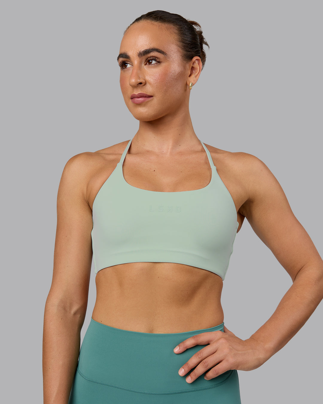 Woman wearing Twist Sports Bra - Surf Spray