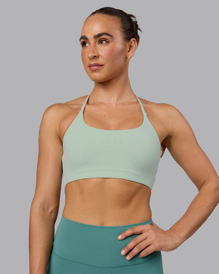 Woman wearing Twist Sports Bra - Surf Spray
