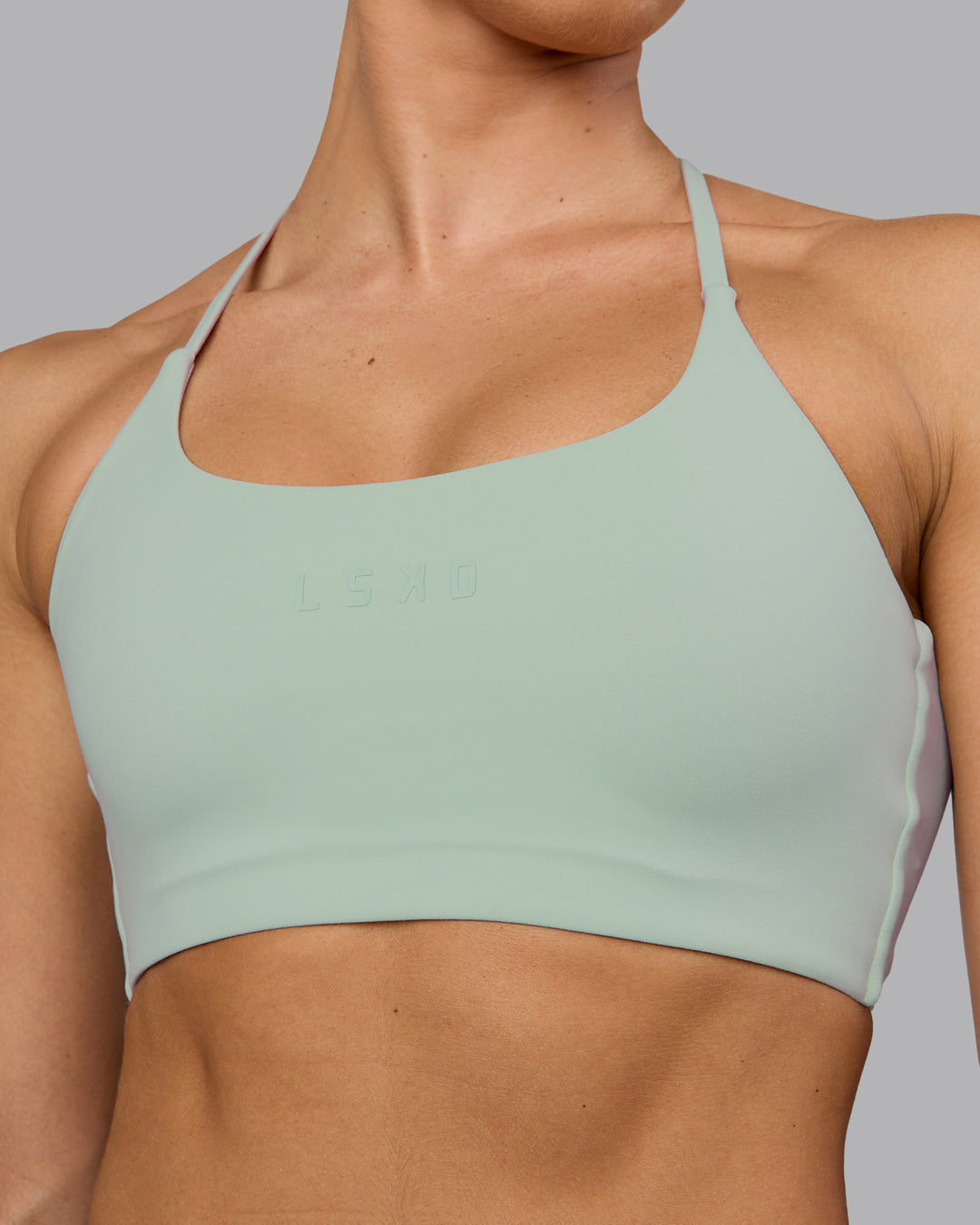 Woman wearing Twist Sports Bra - Surf Spray