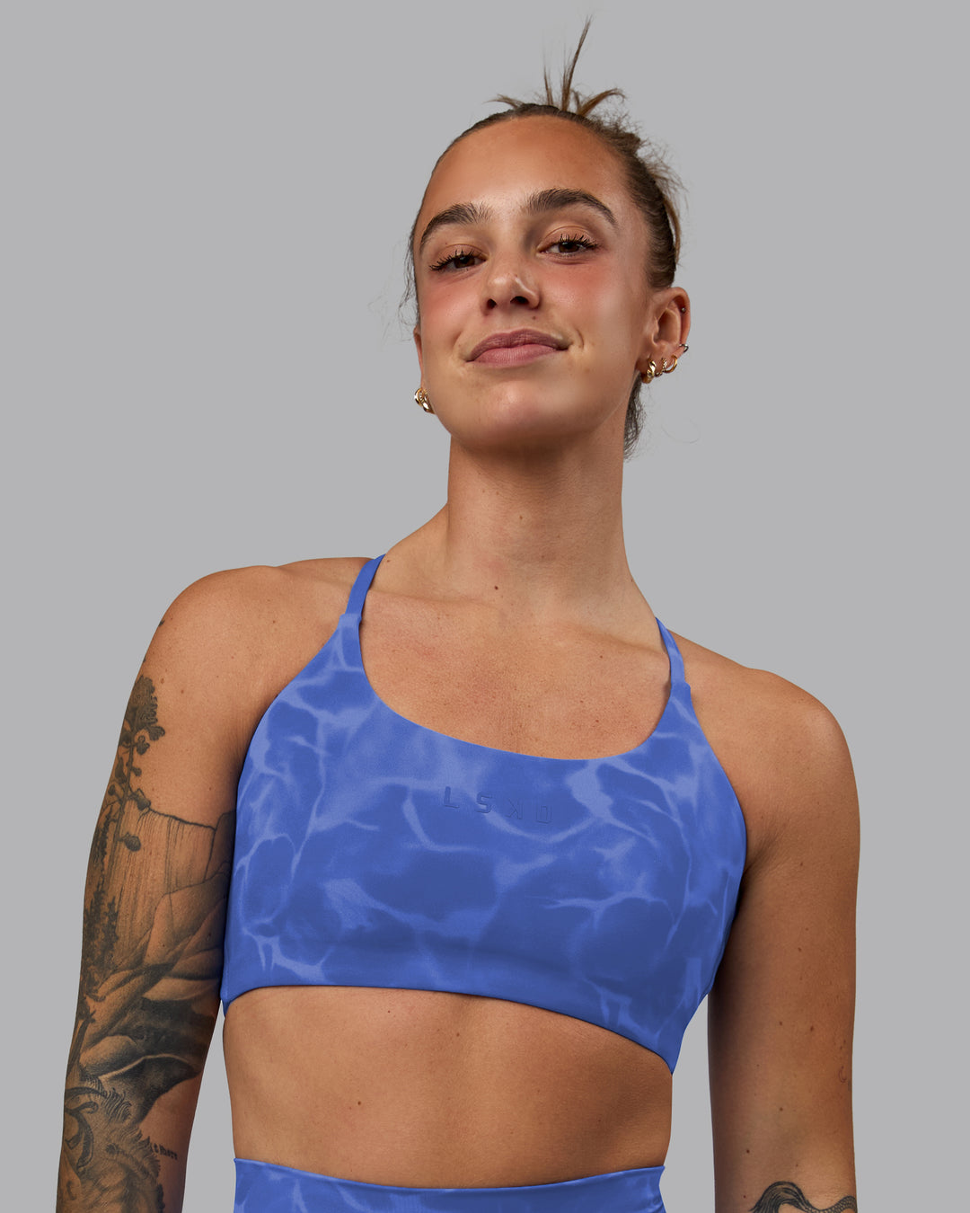 Woman wearing Twist Sports Bra - Tranquil-Power Cobalt