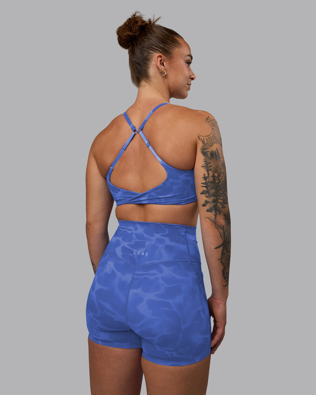 Woman wearing Twist Sports Bra - Tranquil-Power Cobalt