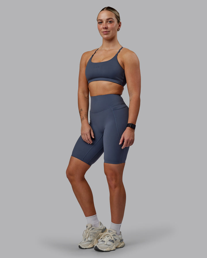 Woman wearing Twist Sports Bra - Turbulence
