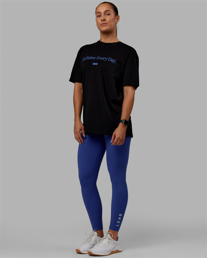 Woman wearing Unisex 1% Better FLXCotton Tee Oversize - Black-Power Cobalt
