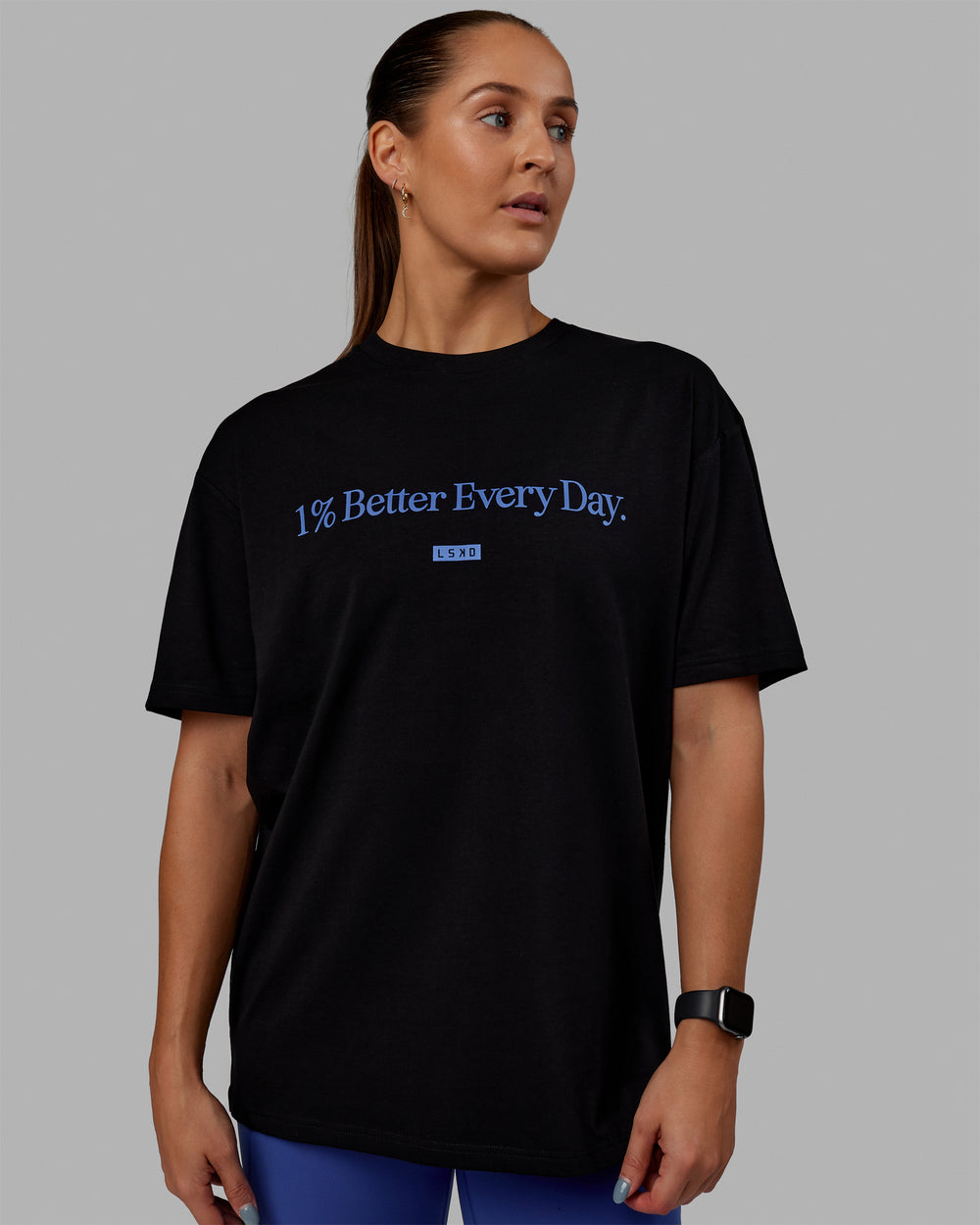 Woman wearing Unisex 1% Better FLXCotton Tee Oversize - Black-Power Cobalt