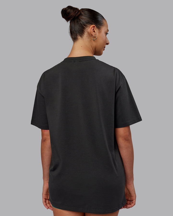 Man wearing Unisex 1% Better FLXCotton Tee Oversize - Pirate Black-Black
