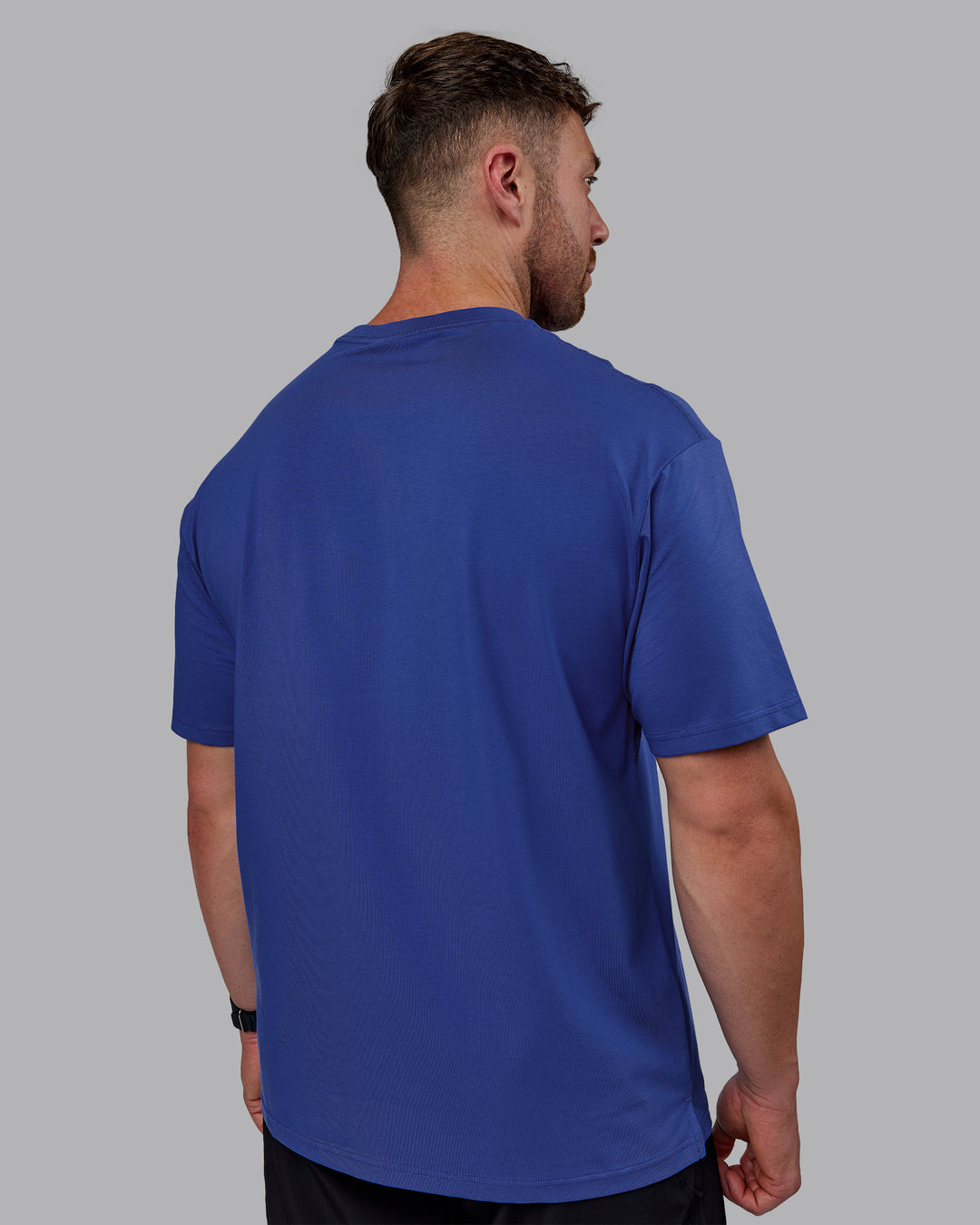 Man wearing Unisex 1% Better FLXCotton Tee Oversize - Power Cobalt-White