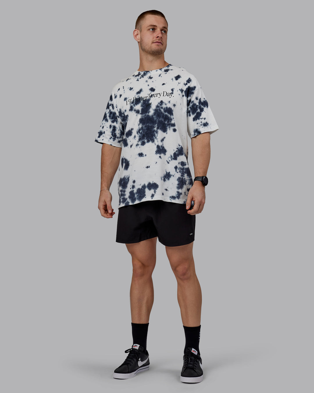 Man wearing Unisex 1% Better Heavyweight Tee Oversize - White-Black Tie Dye