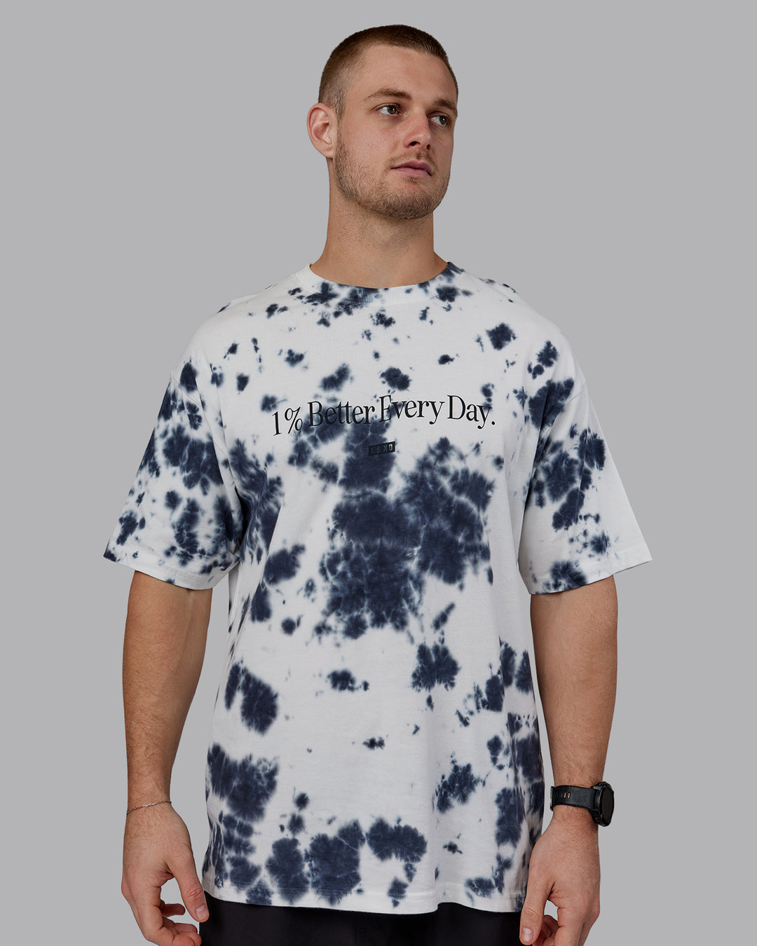 Man wearing Unisex 1% Better Heavyweight Tee Oversize - White-Black Tie Dye