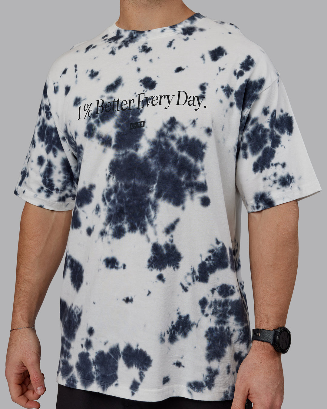 Man wearing Unisex 1% Better Heavyweight Tee Oversize - White-Black Tie Dye