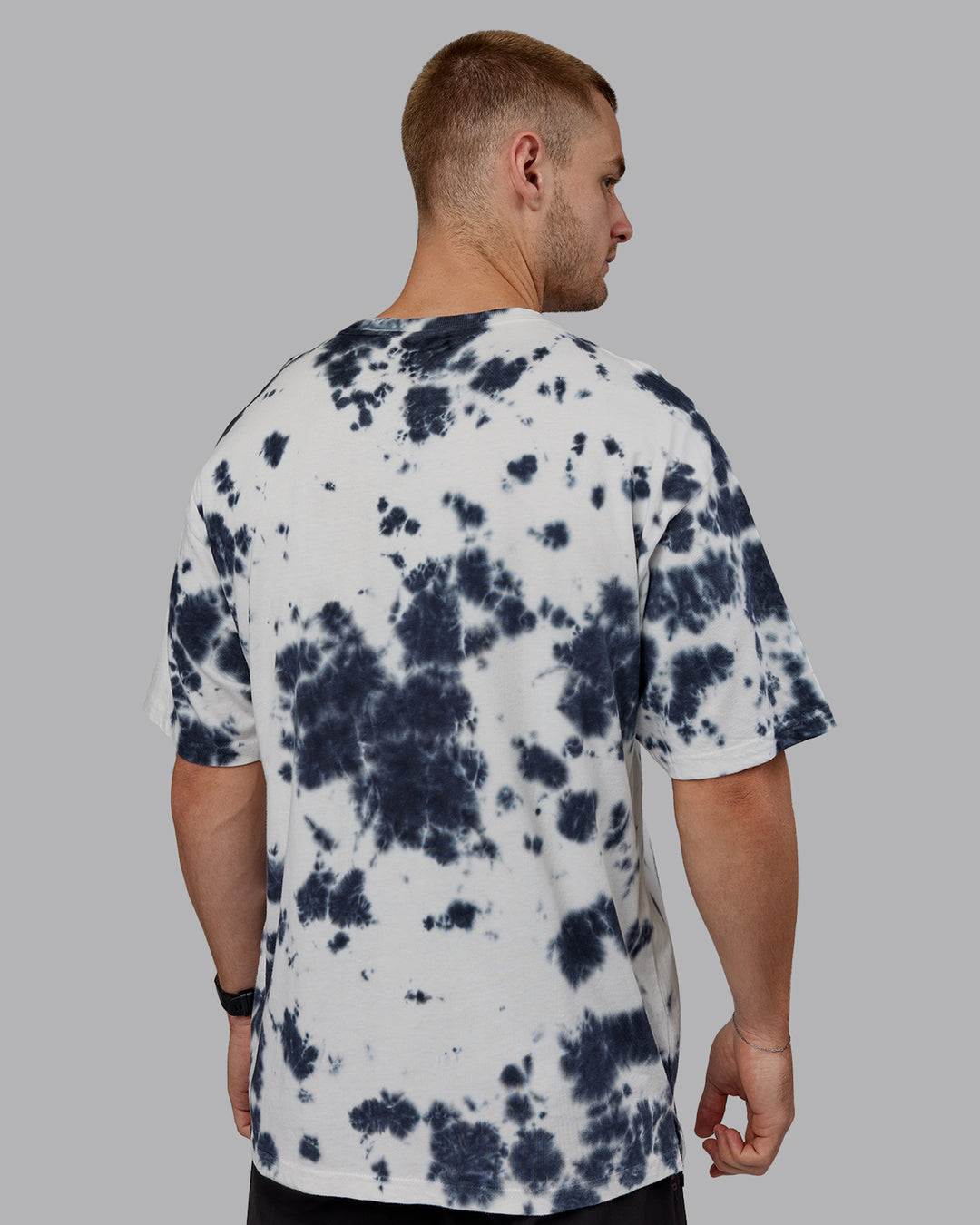 Man wearing Unisex 1% Better Heavyweight Tee Oversize - White-Black Tie Dye