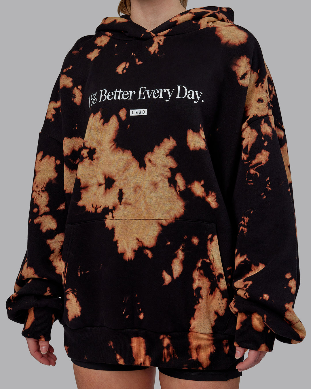 Woman wearing Unisex 1% Better Hoodie Oversize - Black-Bleach-Tie Dye