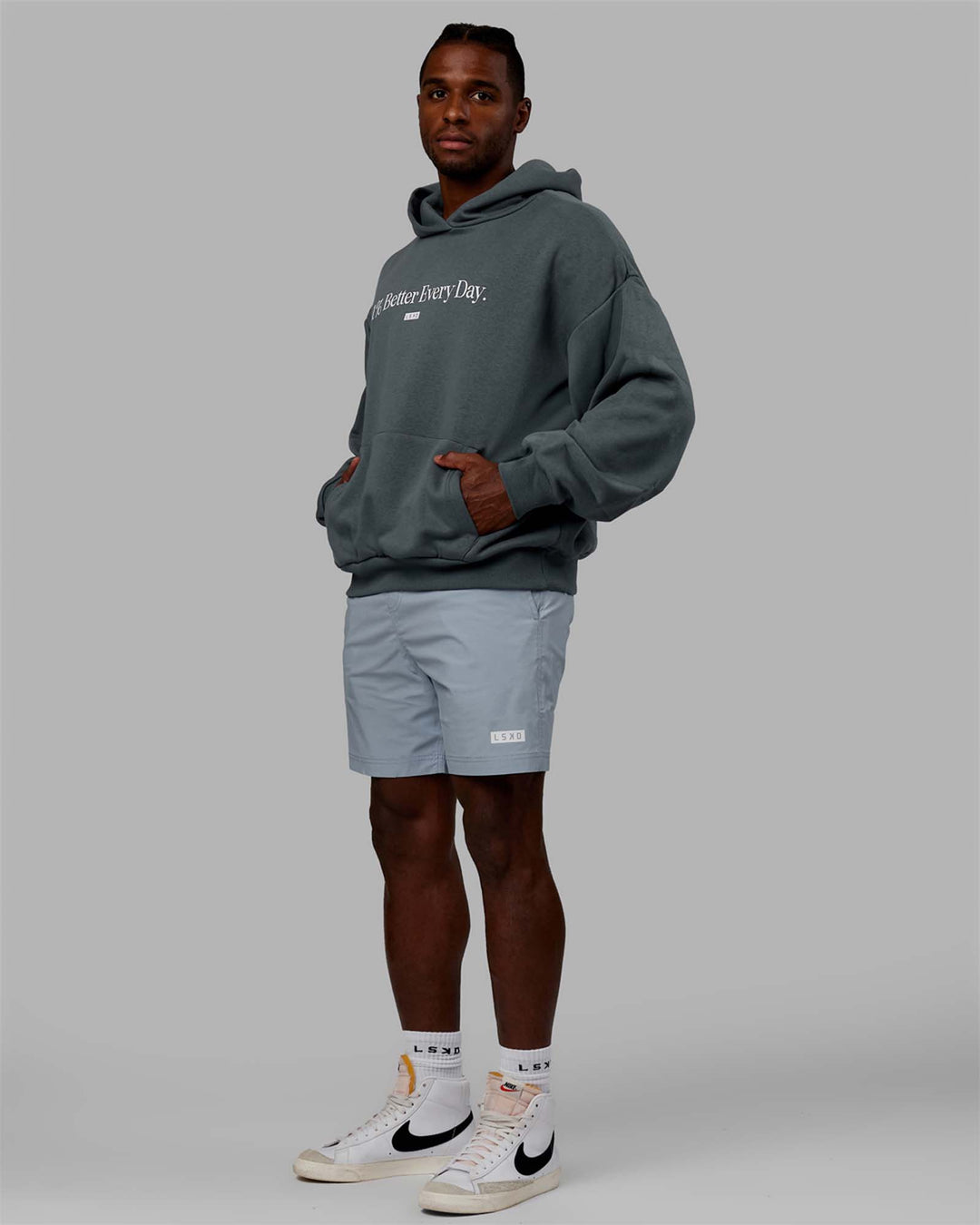 Man wearing Unisex 1% Better Hoodie Oversize - Storm-White