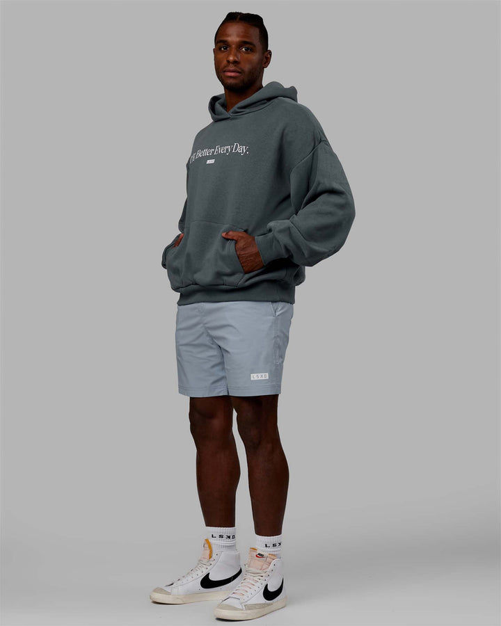 Man wearing Unisex 1% Better Hoodie Oversize - Storm-White
