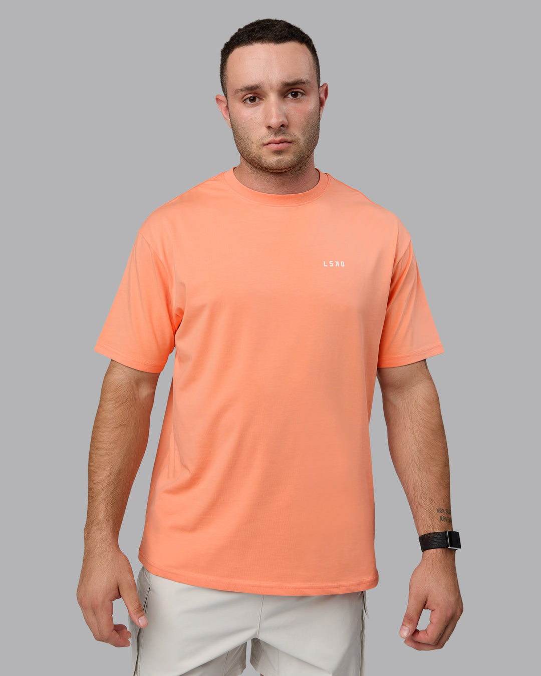 Man wearing Unisex 1% Better Value Series FLXCotton Tee Oversize - Mellow Peach-White