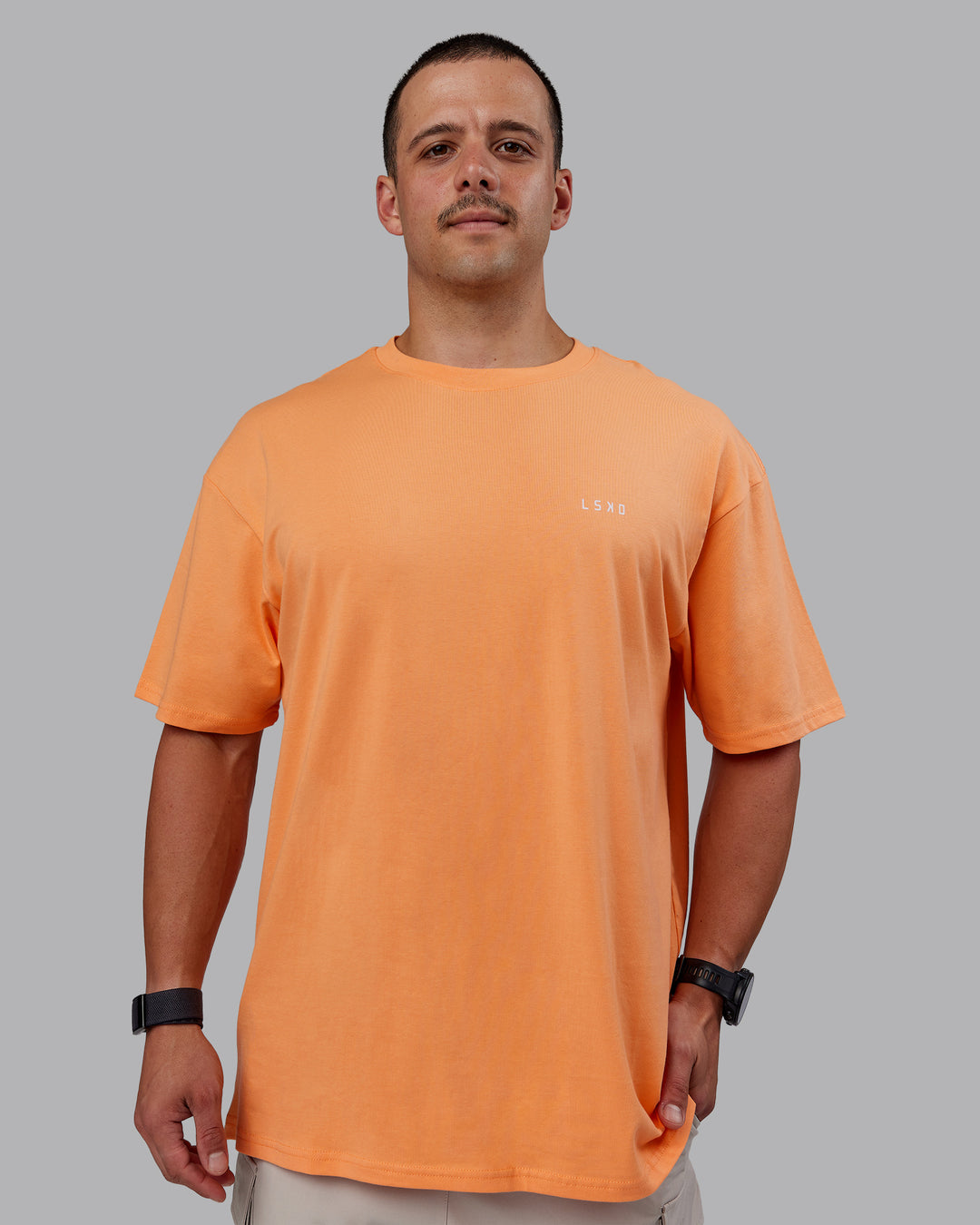 Man wearing Unisex 1% Better Value Series FLXCotton Tee Oversize - Sorbet-Festival Bloom