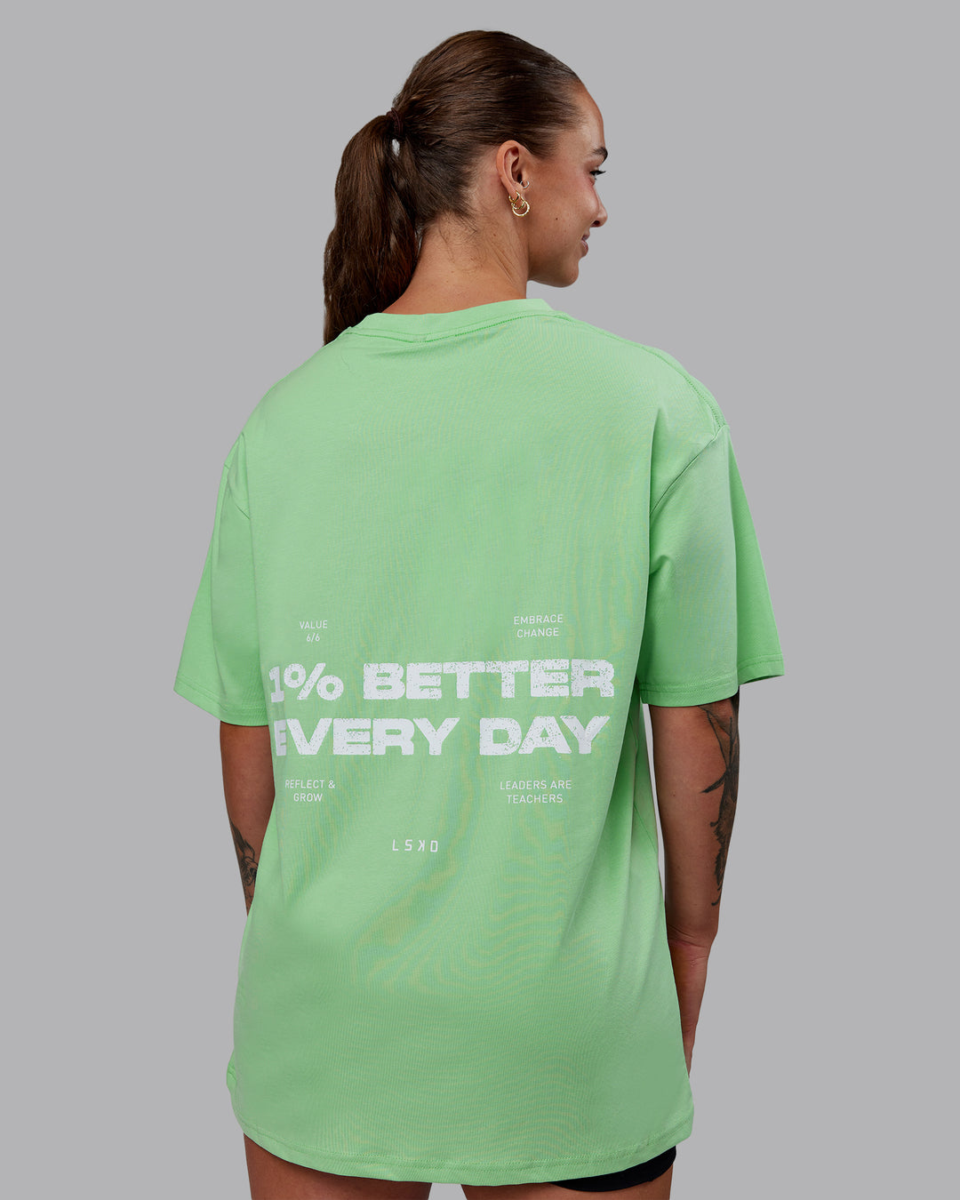 Woman wearing Unisex 1% Better Value Series FLXCotton Tee Oversize - Surreal Green-White