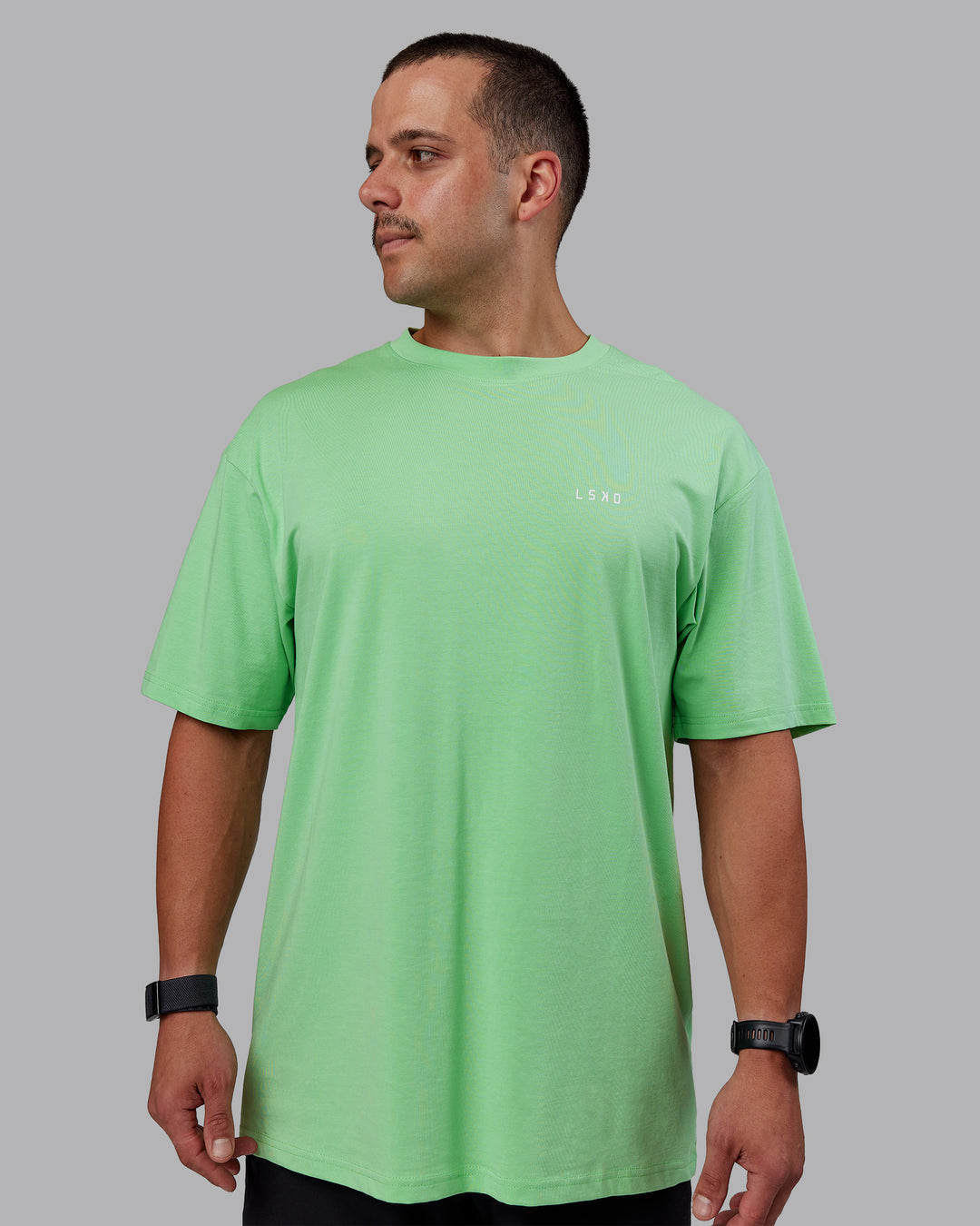 Man wearing Unisex 1% Better Value Series FLXCotton Tee Oversize - Surreal Green-White