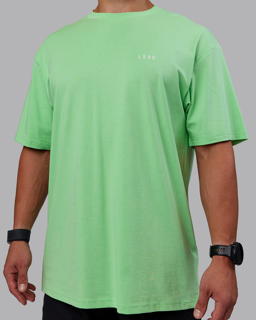 Man wearing Unisex 1% Better Value Series FLXCotton Tee Oversize - Surreal Green-White