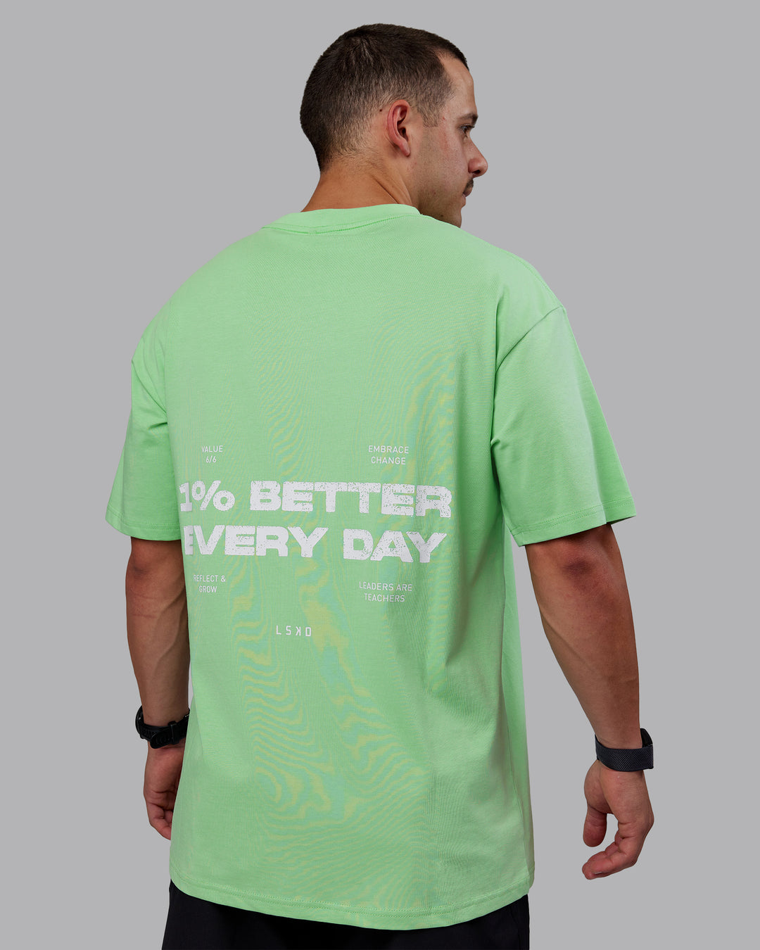 Man wearing Unisex 1% Better Value Series FLXCotton Tee Oversize - Surreal Green-White