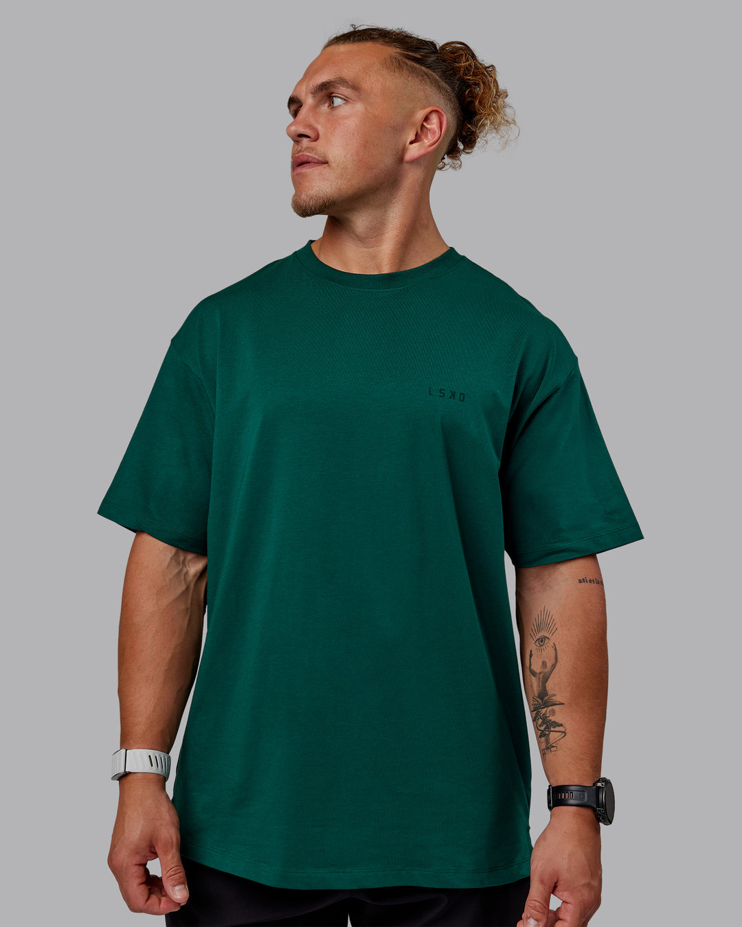 Man wearing Unisex Deluxe PimaFLX Tee Oversize - Deep Emerald