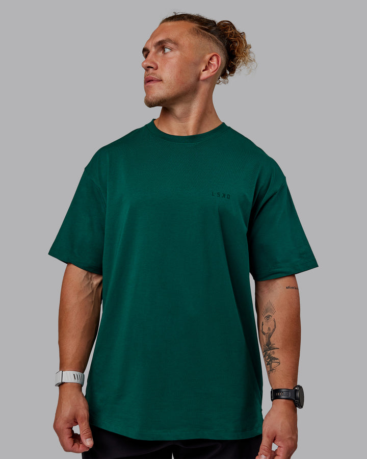 Man wearing Unisex Deluxe PimaFLX Tee Oversize - Deep Emerald
