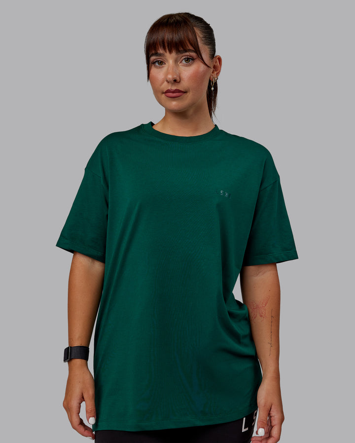 Woman wearing Unisex Deluxe PimaFLX Tee Oversize - Deep Emerald
