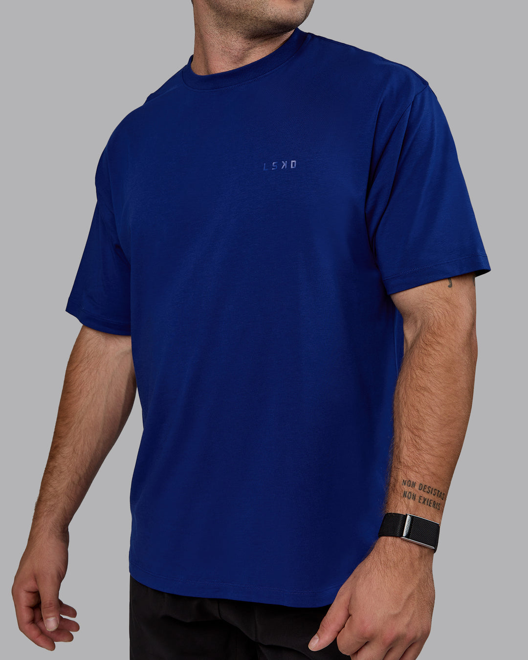 Man wearing Unisex Deluxe PimaFLX Tee Oversize - Midnight Blue