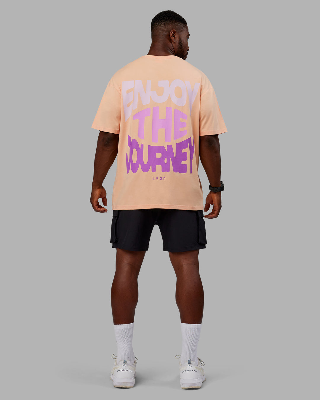 Man wearing Unisex E.T.J FLXCotton Tee Oversize - Peach Fuzz-Purple