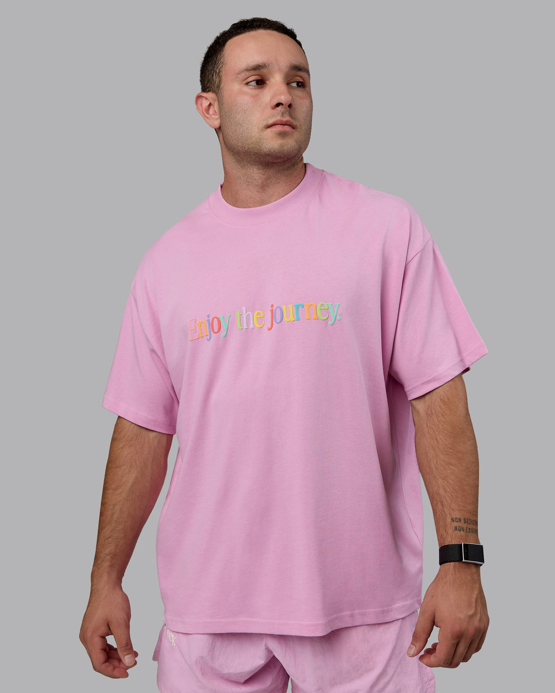 Man wearing Unisex Enjoy The Journey Heavyweight Tee Oversize - Bubblegum-Multi