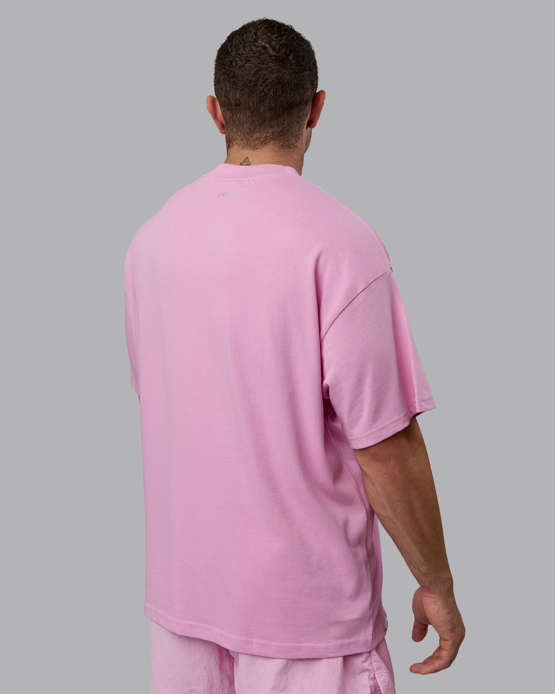 Man wearing Unisex Enjoy The Journey Heavyweight Tee Oversize - Bubblegum-Multi