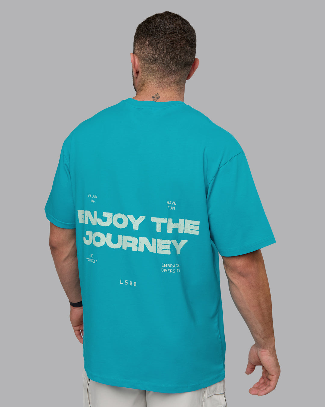 Man wearing Unisex Enjoy the Journey Value Series FLXCotton Tee Oversize - Bluebird-Surf Spray