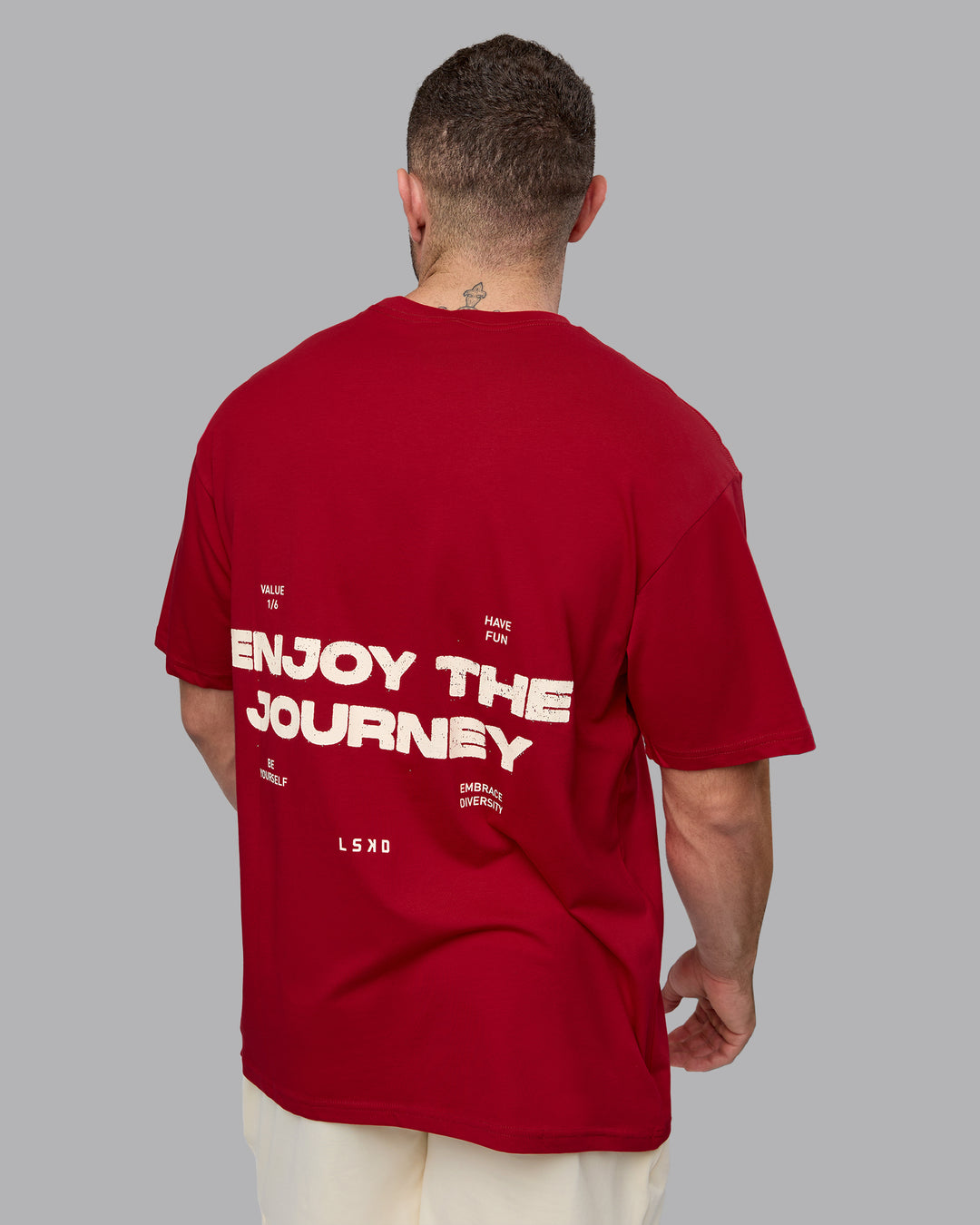 Man wearing Unisex Enjoy the Journey Value Series FLXCotton Tee Oversize - Cherry Red-Ivory