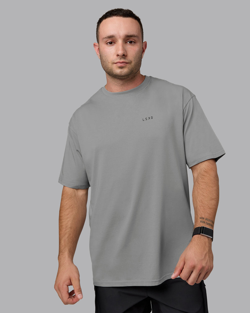 Man wearing Unisex Enjoy the Journey Value Series FLXCotton Tee Oversize - Circular Grey-Pirate Black